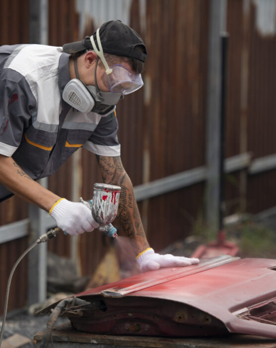 man-painting-car-door-side-view
